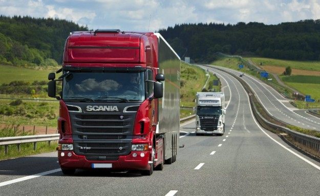 Autocarro rosso Marastoni Trasporti in viaggio su autostrada